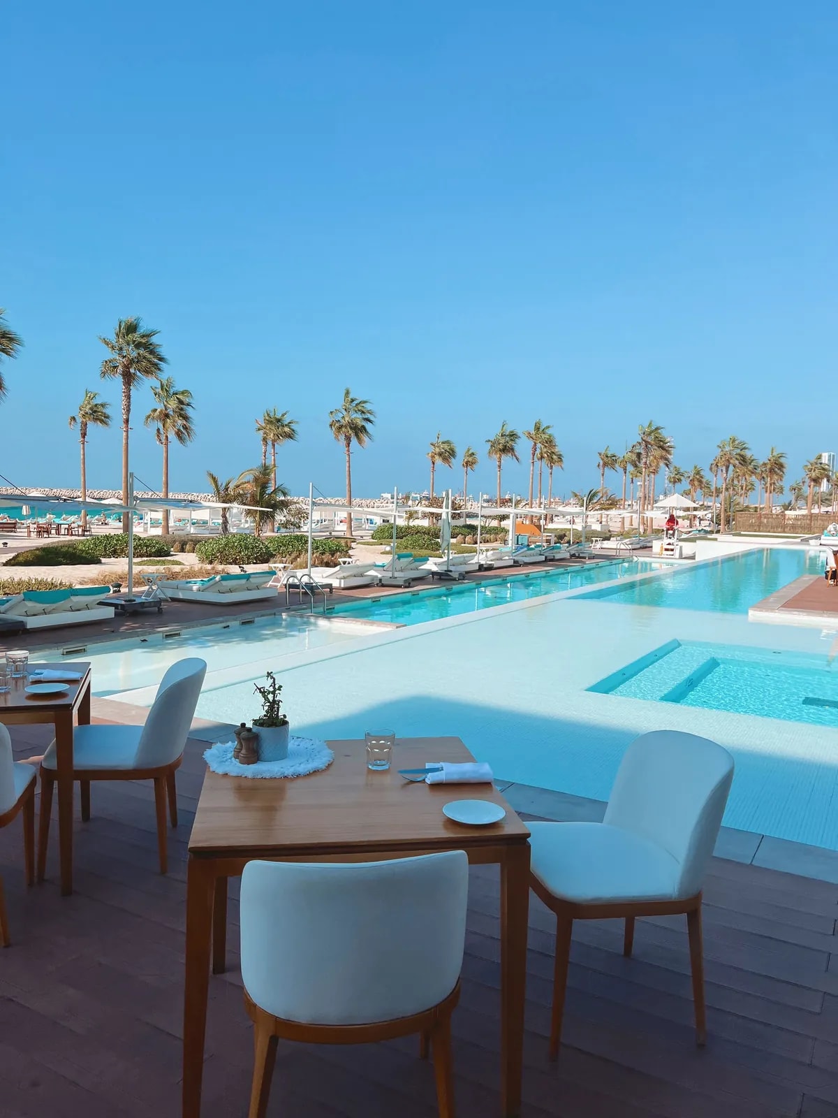 Poolside at Nikki Beach on Pearl Jumeirah, the beachfront island where we automate custom villas