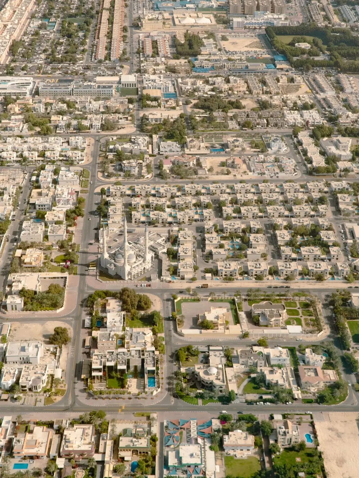 Aerial view of walled villa plots and streets, like the Al Warqa villas we automate