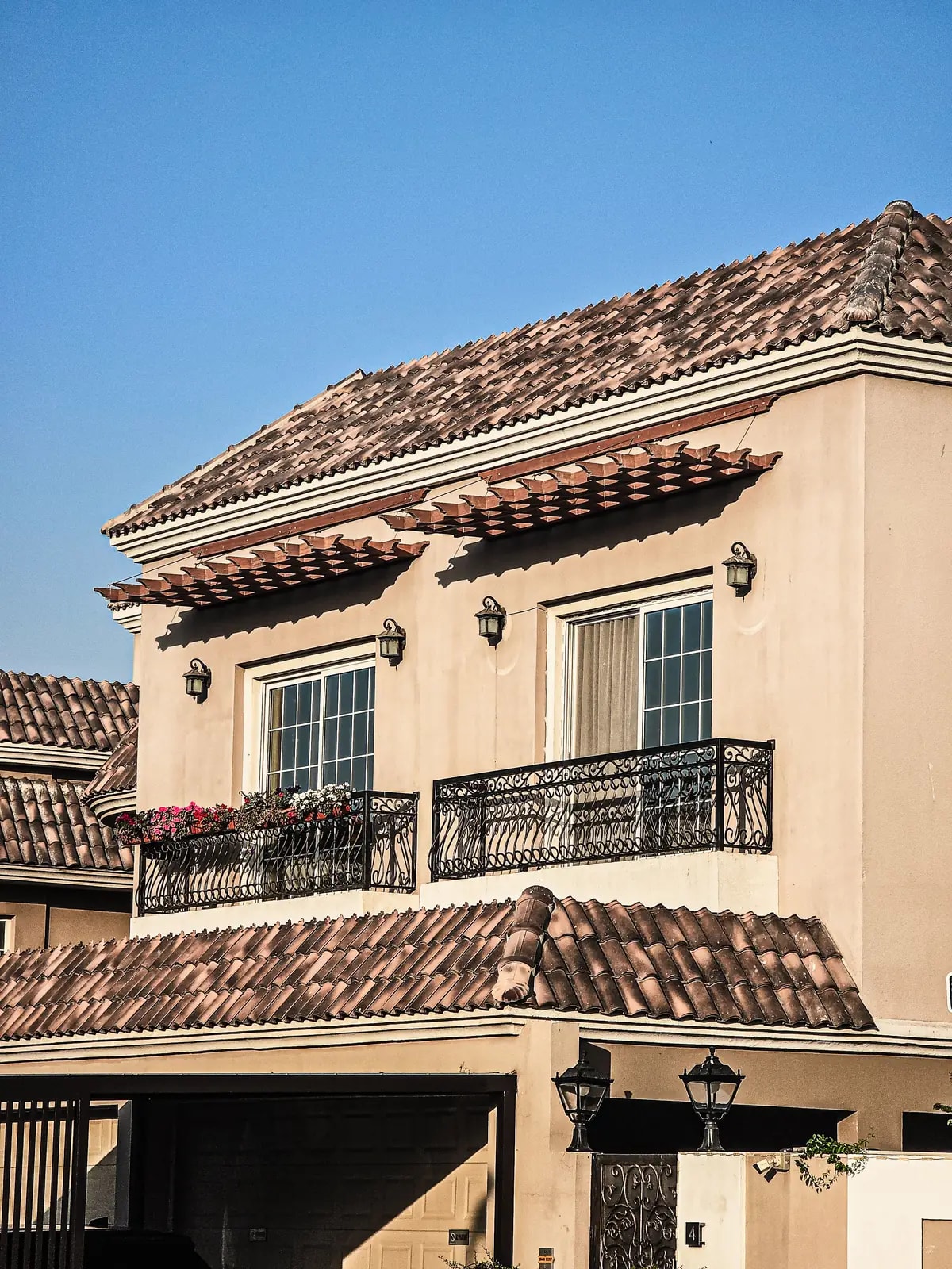 Two-storey villa with terracotta tiles and iron balconies, like the Arabian Ranches 2 homes we automate