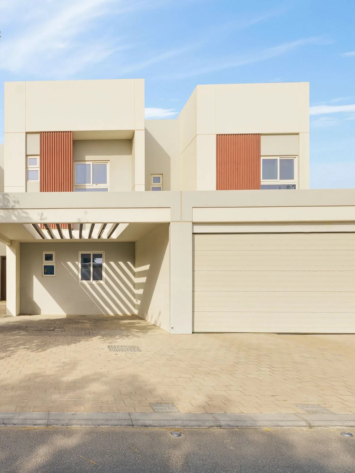 Cream townhouse with orange panels and a garage, like the Arabian Ranches 3 townhouses we automate