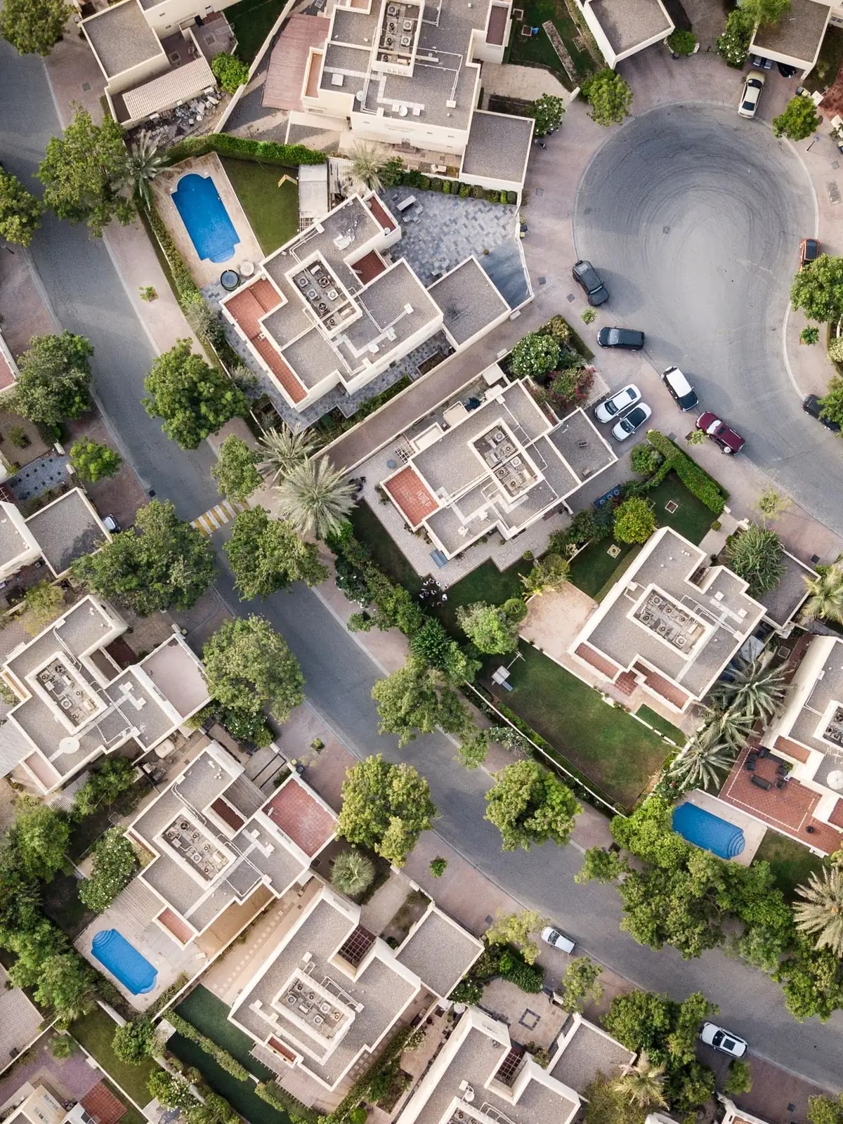 Aerial view of villas with private pools and gardens, like the DAMAC Lagoons homes we automate