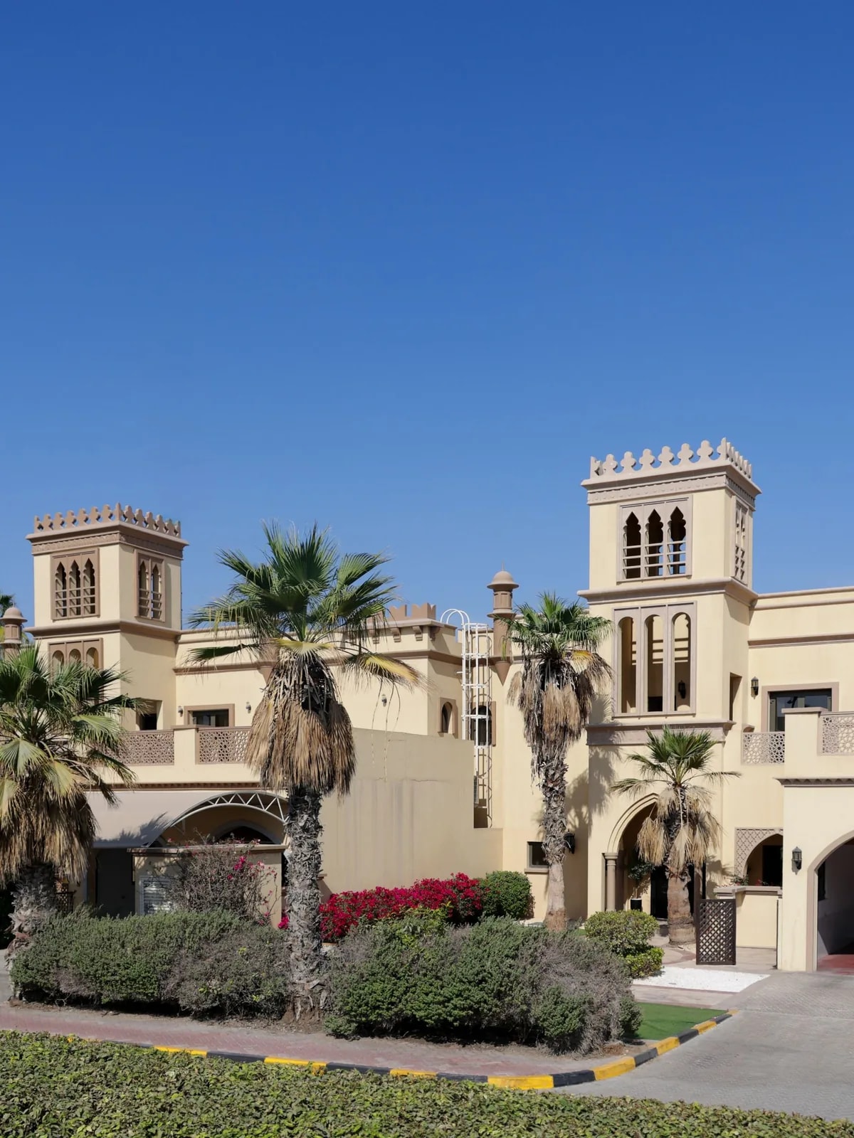 Arched Arabian-style villa with palm trees and a garden, like the Jumeirah Park villas we automate