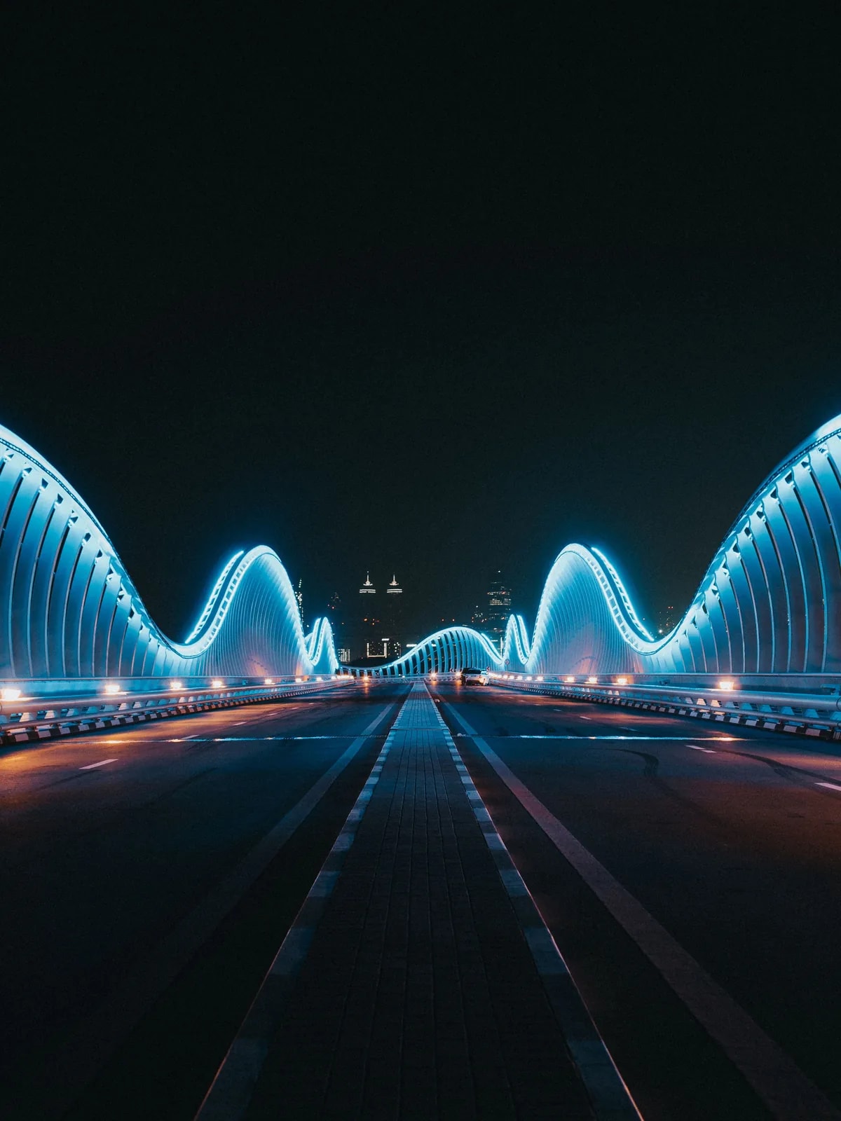 Meydan Bridge lit blue at night in Mohammed Bin Rashid City, where we design home automation