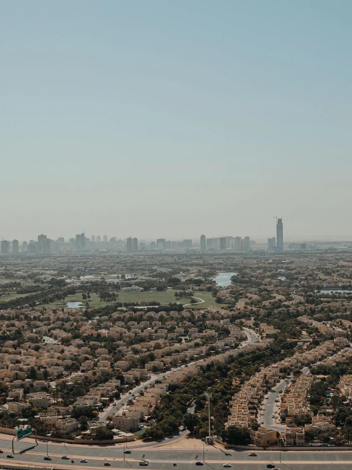 Aerial view of townhouse rows, trees and a lake, like The Springs townhouses we automate