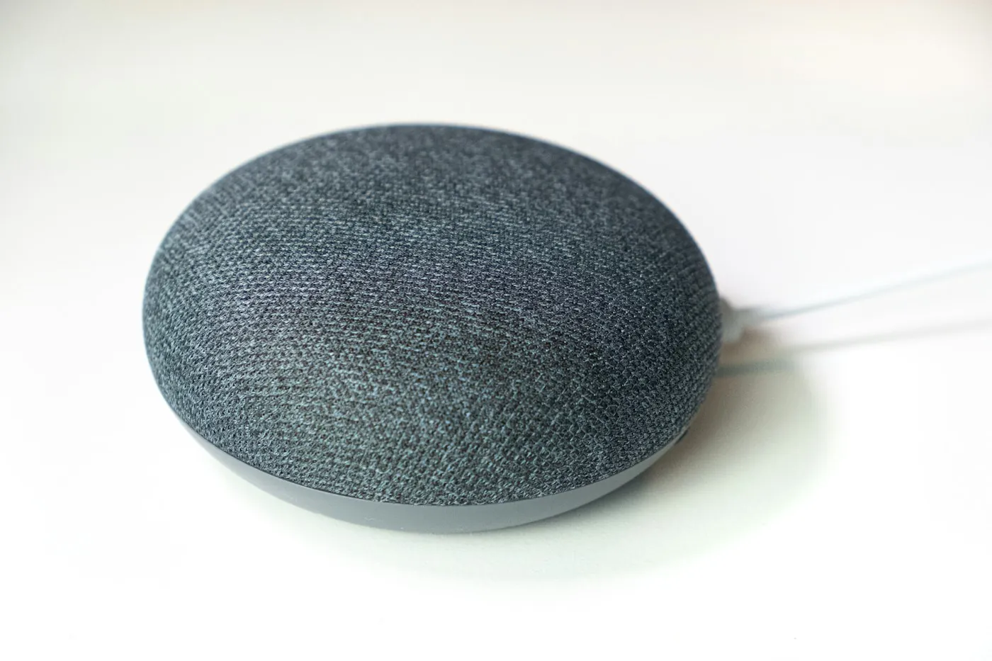 A compact smart speaker used for voice commands in a home