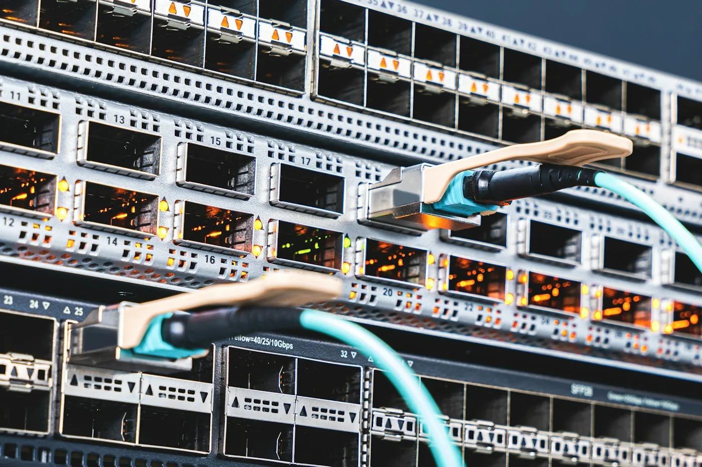 Numbered, labelled network switch ports in a rack with a patch cable connected