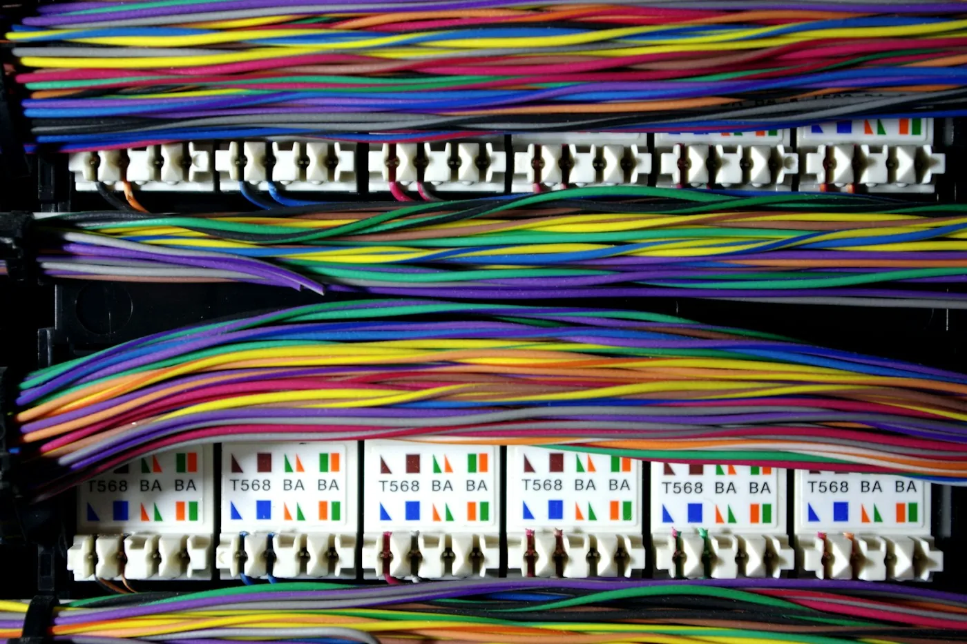 Colour-coded structured cabling terminated onto labelled T568 patch panel ports