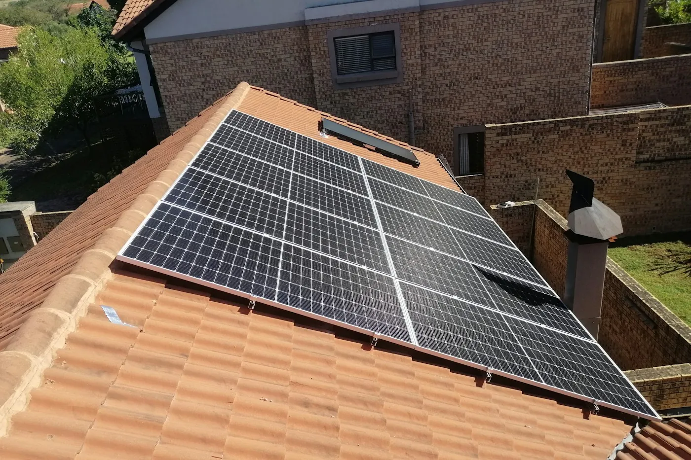 Solar panels installed on a sunlit tiled villa roof