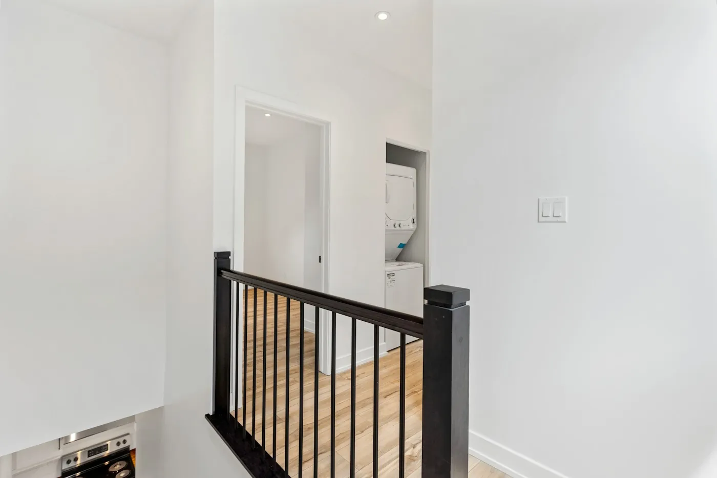 Bright upper-floor landing and staircase in a modern villa, the kind of concrete separation a Wi-Fi signal has to cross